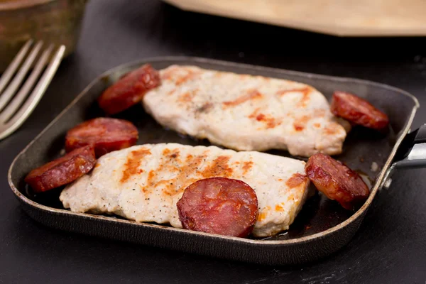 Fried pork with sausages — Stock Photo, Image