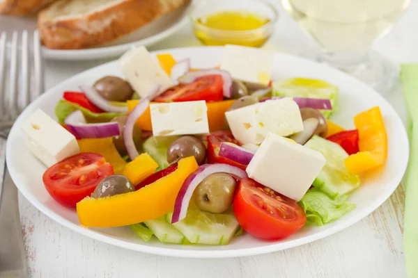 Salad with olives and cheese on the plate — Stock Photo, Image