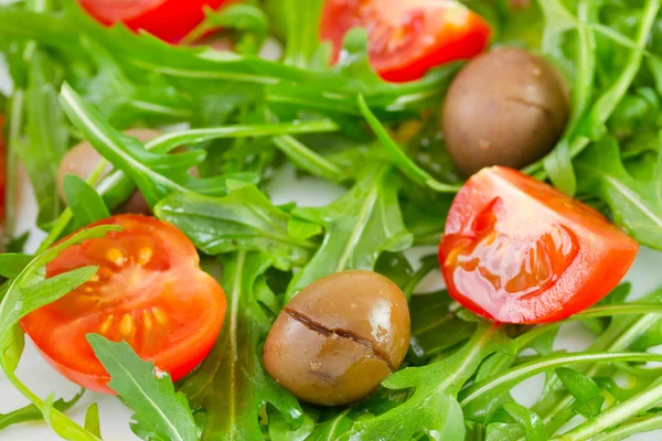 Rucola med gröna oliver och tomat körsbär — Stockfoto