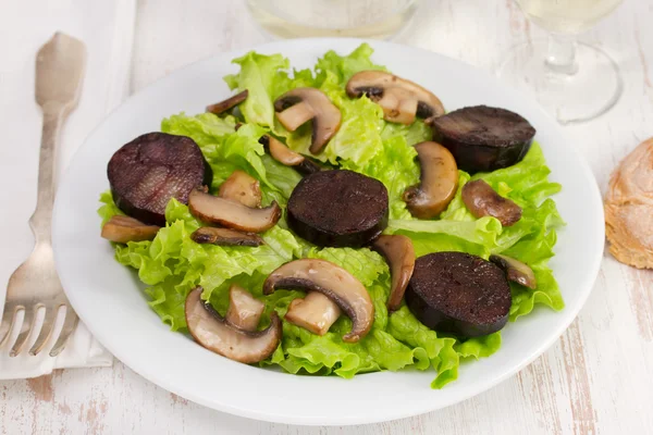 Салат с жареными колбасами и портобелло — стоковое фото