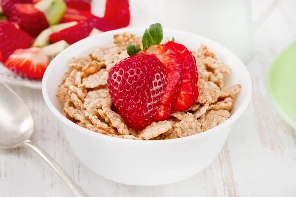 Cereals with strawberry in bowl with spoon — Stock Photo, Image