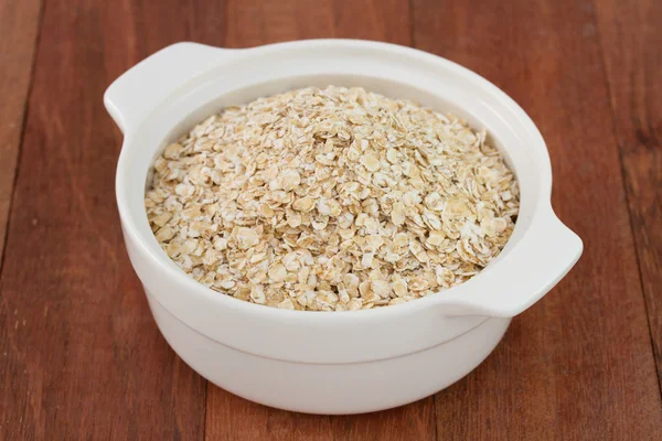 Oat flakes in the bowl — Stock Photo, Image