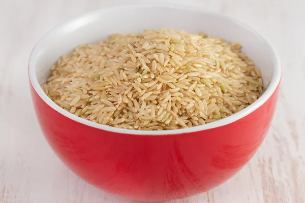 Dry rice in red bowl — Stock Photo, Image