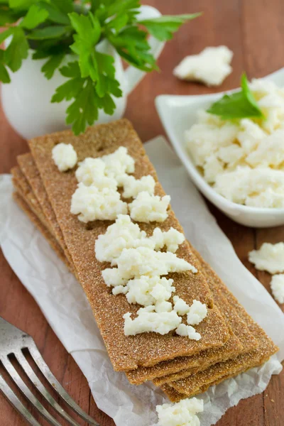 Toasts with cottage cheese on paper — Stock Photo, Image