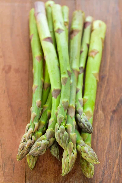 Asparagus on brown table — Stock Photo, Image
