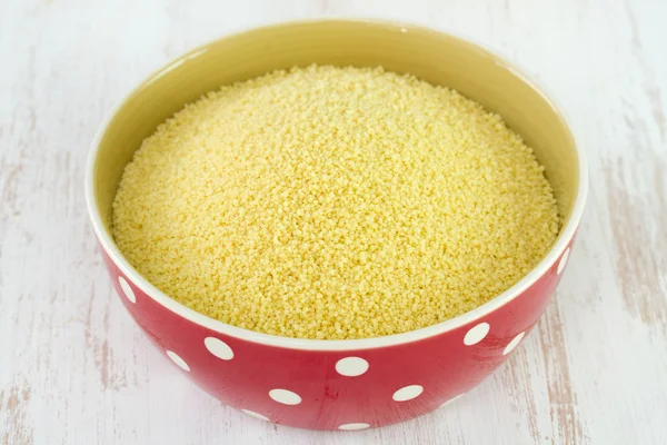Couscous in bowl on white table — Stock Photo, Image