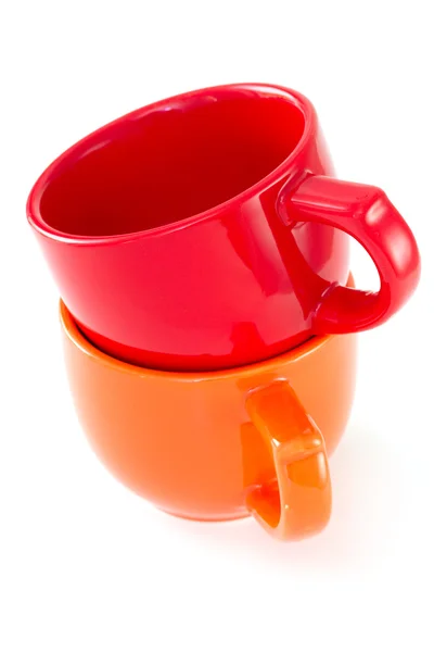 Red and orange cups on white background Royalty Free Stock Images