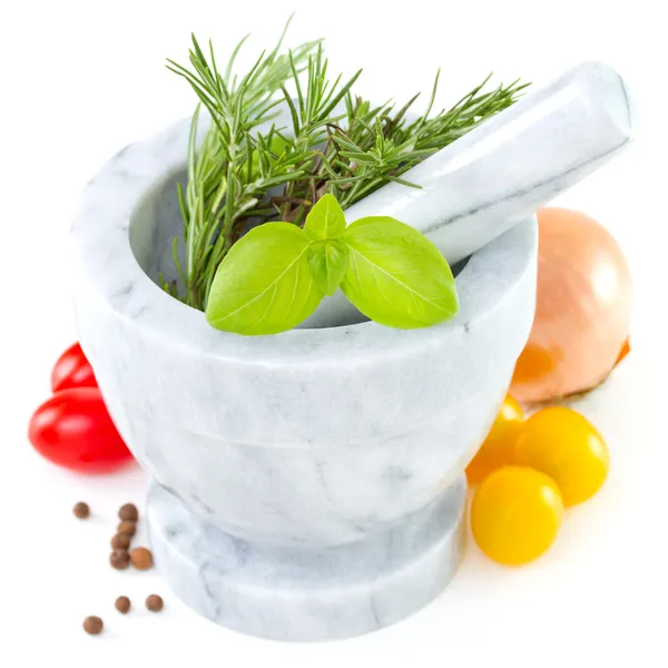Herbs in mortar with tomato — Stockfoto