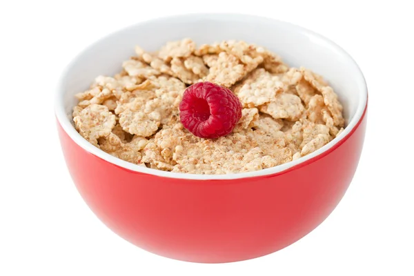 Flakes with raspberries in bowl on white background — Stock Photo, Image