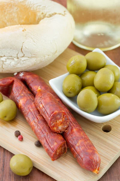 Sausages with olives and bread — Stock Photo, Image