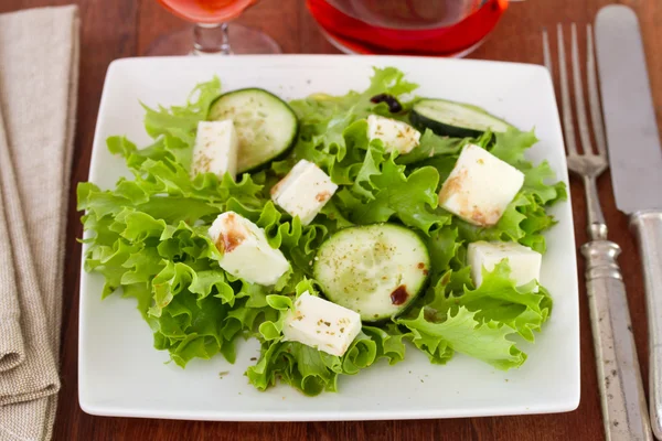 Salad with mozzarella on white plate — Stock Photo, Image