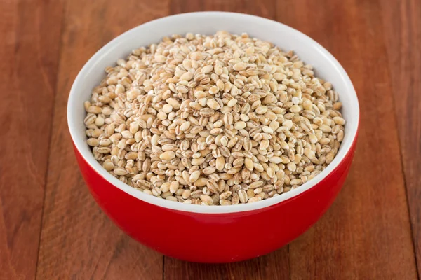 Pearl barley in red bowl — Stock Photo, Image