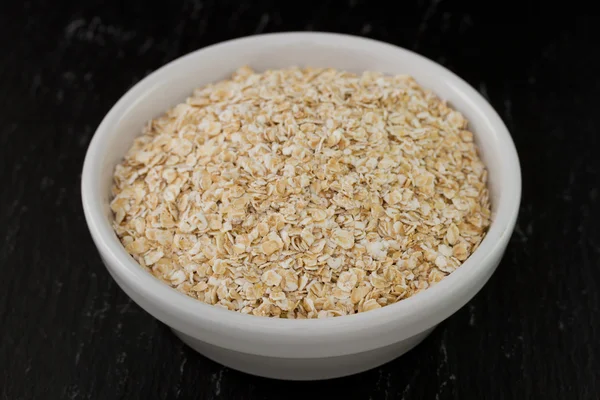 Oatmeal in white small bowl — Stock Photo, Image