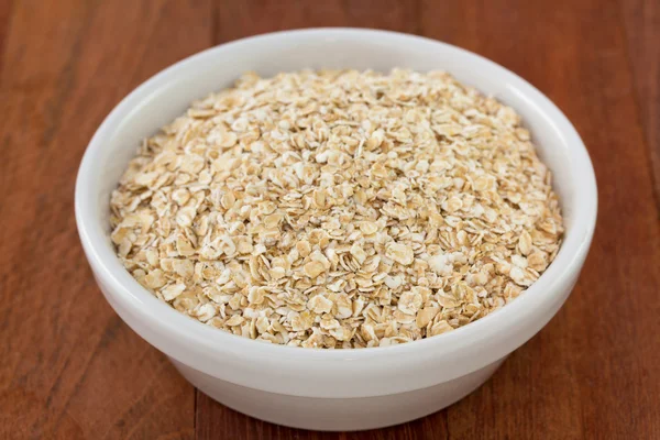 Oatmeal in white small bowl — Stock Photo, Image