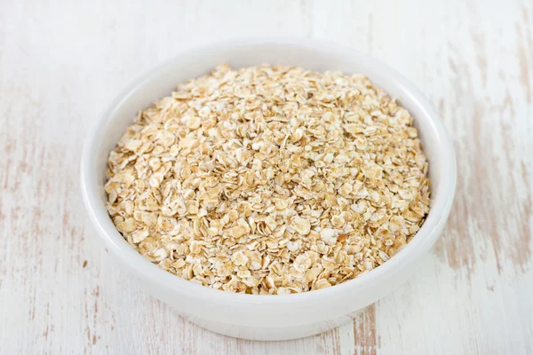 Oatmeal in white small bowl Royalty Free Stock Photos