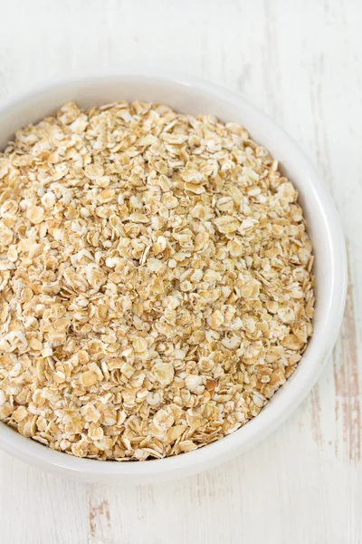Oatmeal in white small bowl Stock Image