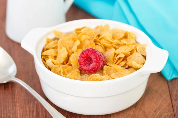 Flakes with raspberry in white bowl — Stock Photo, Image