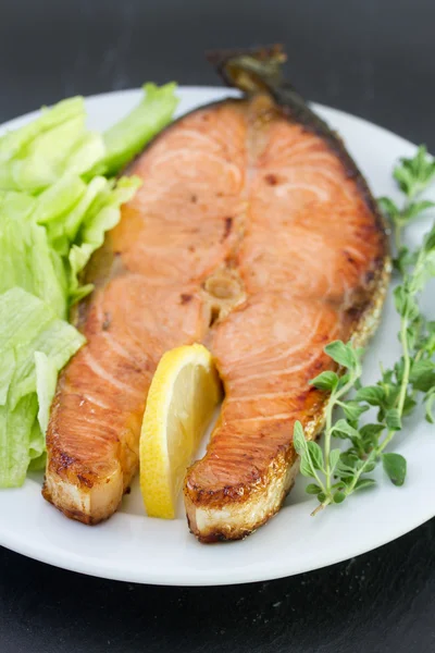 Salmon with salad on the white plate — Stock Photo, Image