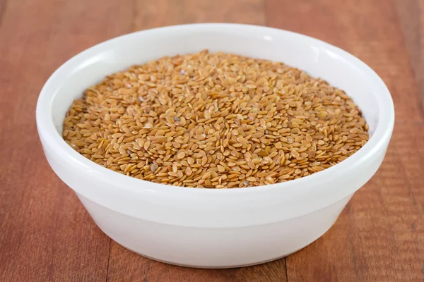 Linseed in white bowl — Stock Photo, Image