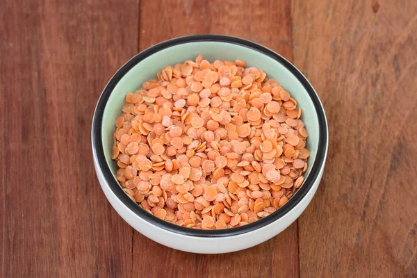 Lentil in dish on dark background — Stock Photo, Image