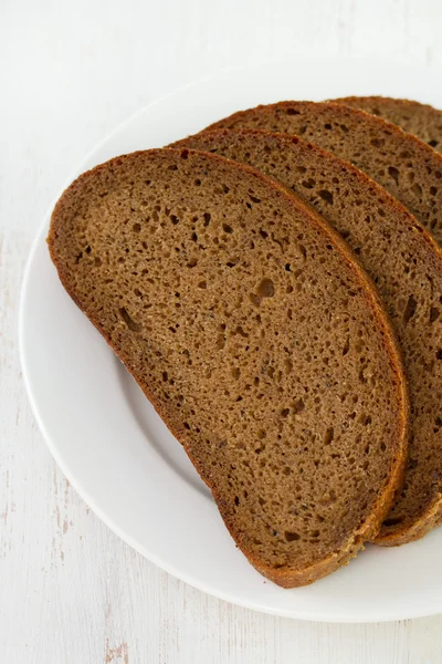 Dark bread on plate — Stock Photo, Image