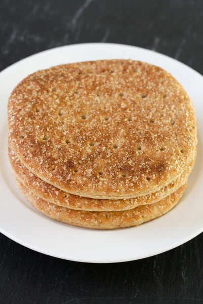 Bread on plate on dark background — Stock Photo, Image