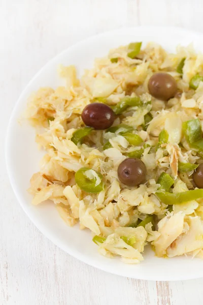 Salad with codfish and vegetables on white plate — Stock Photo, Image