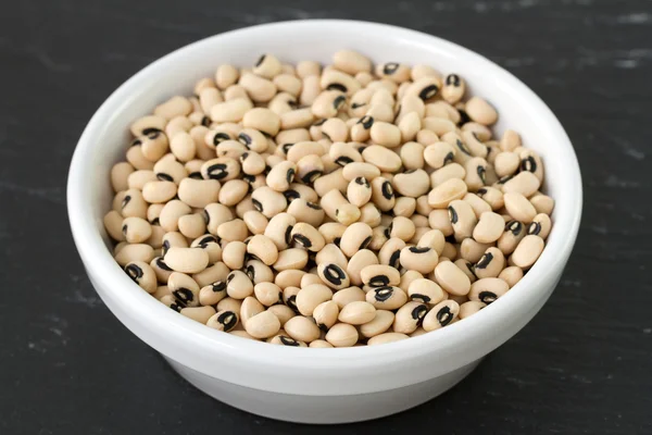 Beans in bowl in black background — Stock Photo, Image