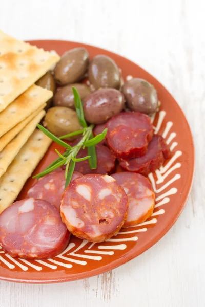 Sausages with olives on plate — Stock Photo, Image