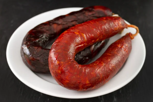 Sausages on white plate — Stock Photo, Image