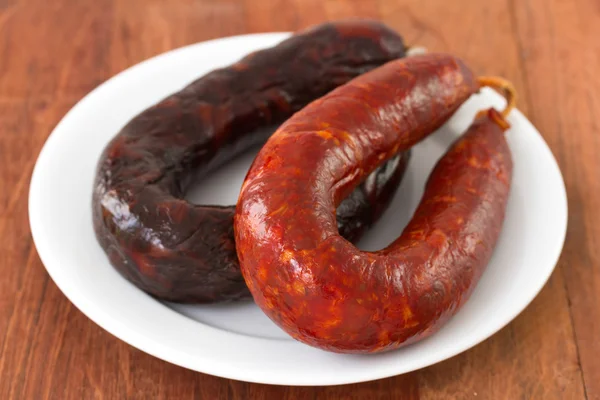 Sausages on white plate — Stock Photo, Image