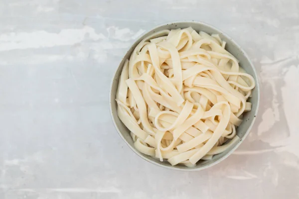 boiled noodle Udon on ceramic bowl on gray ceramic