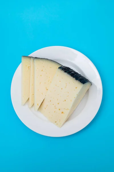 Slices Cheese White Small Plate Blue Paper — Foto de Stock
