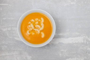 vegetable soup with pasta in white bowl