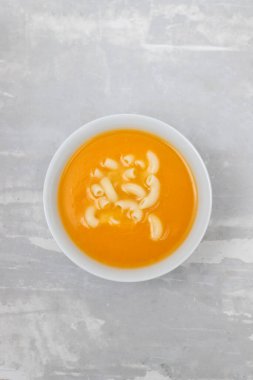 vegetable soup with pasta in white bowl