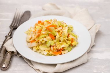 salad fresh cabbage with carrot on white dish on ceramic