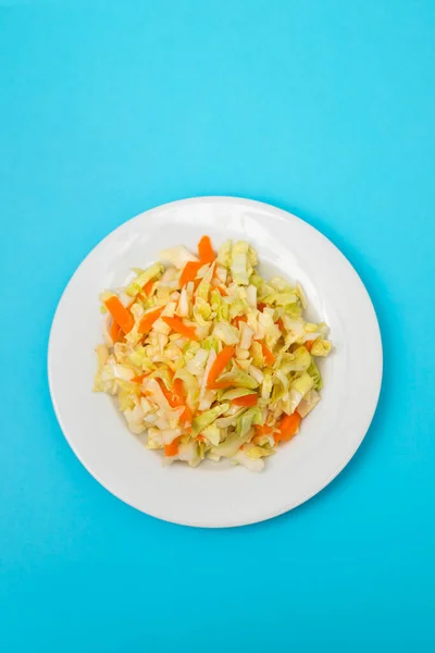 Salad Fresh Cabbage Carrot White Dish Blue Paper — Zdjęcie stockowe