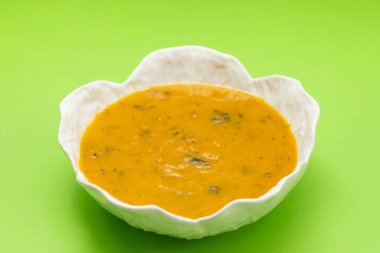 Ispanaklı sebze çorbası güzel bir kase içinde ve kaşık seramikte.