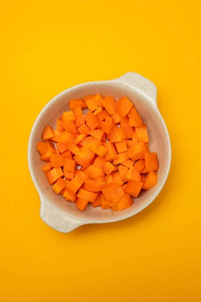 Cut Cubes Fresh Carrot Bowl Yellow Paper — Stock Photo, Image