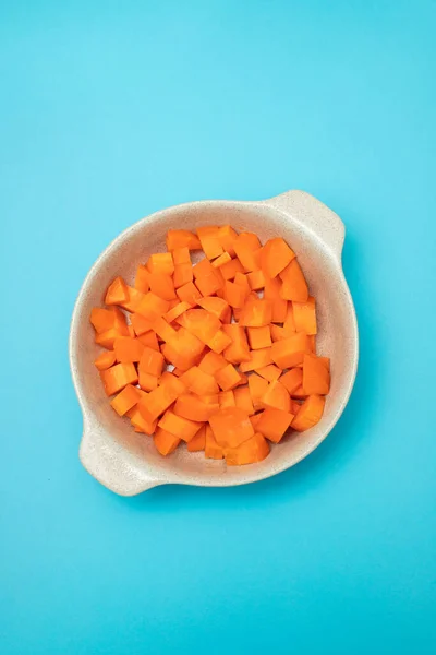 Cut Cubes Fresh Carrot Bowl Blue Paper — Stock Photo, Image