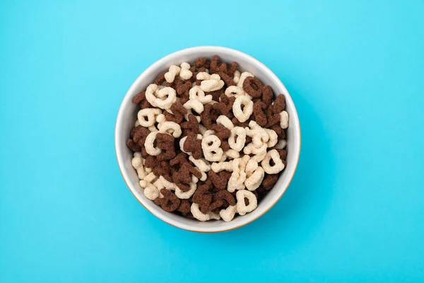 simple and chocolate cereals letters in orange bowl