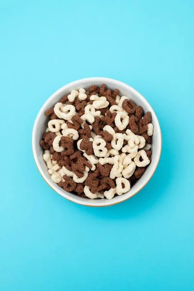Simple and chocolate cereals letters in orange bowl — Foto de Stock