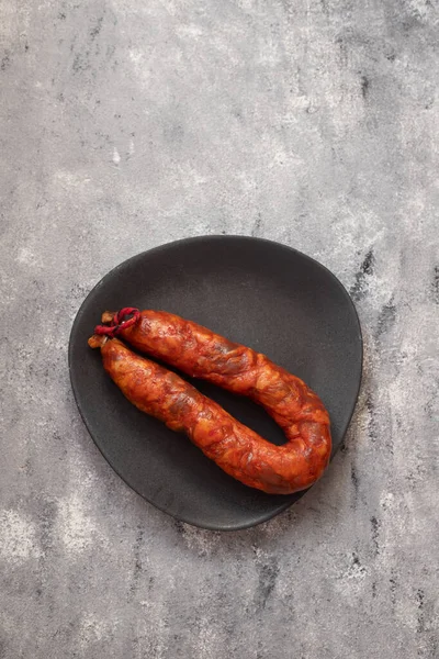 typical portuguese smoked sausage on the plate on gray