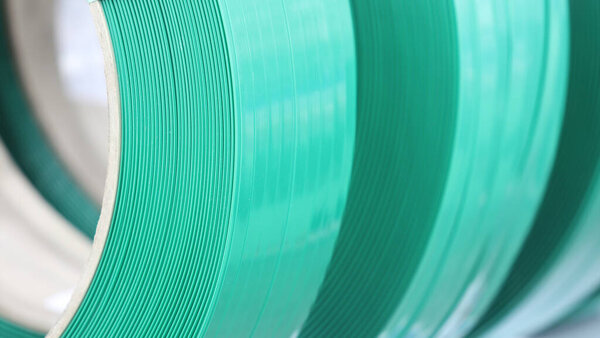 Green PP band for packaging and fastening of carton box ; Business industrial background 