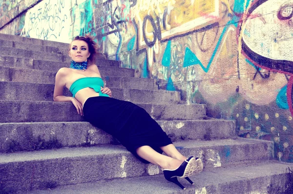 Beautiful futuristic woman lying on steps — Stock Photo, Image