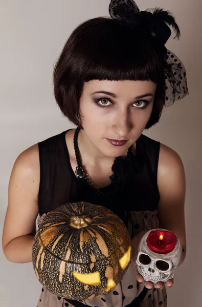 Pretty girl - witch with skull and a pumpkin — Stock Photo, Image