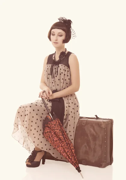 Beautiful brunette girl with umbrella and old suitcase — Stock Photo, Image