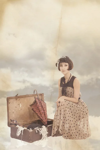 Vintage collage with beautiful brunette girl in clouds — Stock Photo, Image