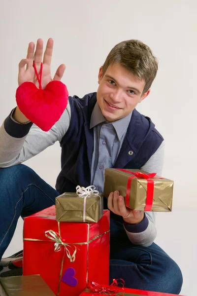 Teenager with heart and gifts — Stock Photo, Image