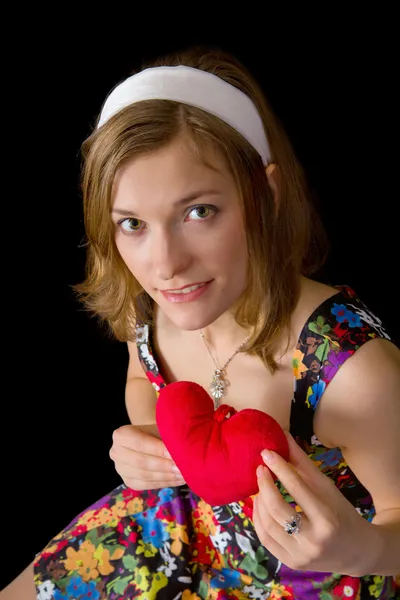 Beautiful girl holding toy heart — Stock Photo, Image